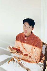 Portrait of boy sitting at home