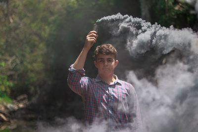 Full length of young man looking away outdoors