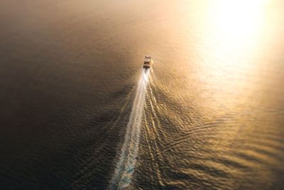 High angle view of boat moving on sea during sunset