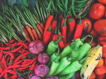 High angle view of chili, unions, carrots and other vegetables in market