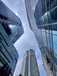 Low angle view of buildings against cloudy sky