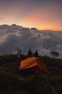 Tent on field against sky during sunset