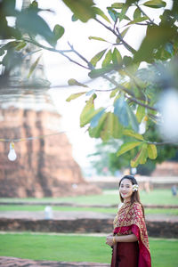 Portrait of woman in traditional clothing standing outdoors