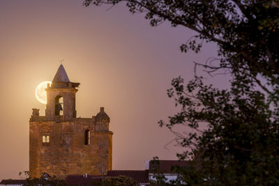 Historic building against sky at sunset