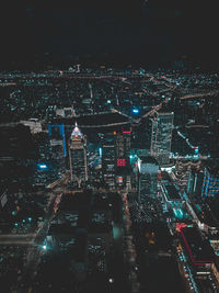 High angle view of illuminated cityscape against sky at night