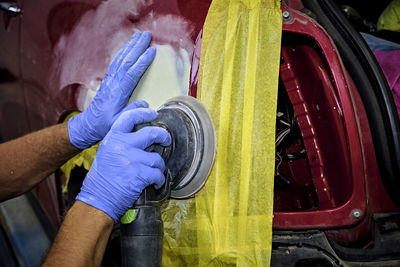 Close-up of hands working on motorcycle