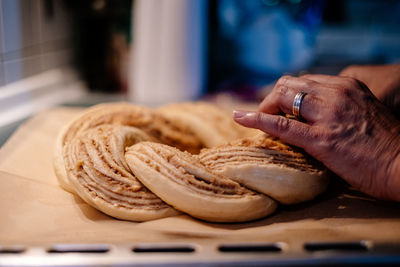 Close up of human hand preaparing easter cake dough