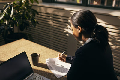 Side view of woman using mobile phone
