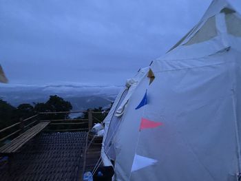 Low angle view of flags hanging against sky