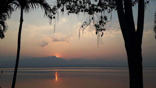 Scenic view of lake against orange sky