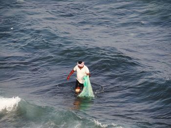 High angle view of man wading in sea