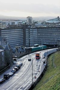 High angle view of vehicles on street by buildings