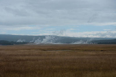 Scenic view of landscape against cloudy sky