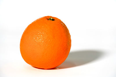 Close-up of orange slice against white background