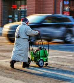 Rear view of man working on street