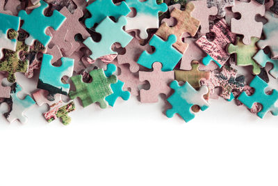 High angle view of multi colored pencils on white background