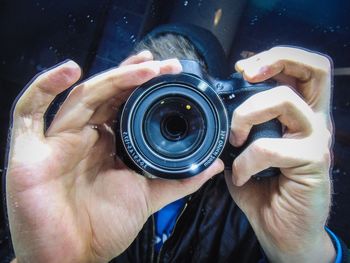 Midsection of person holding camera