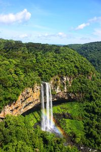 Scenic view of waterfall against sky