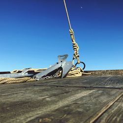 Low angle view of metallic structure against blue sky