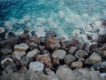 High angle view of stones in sea