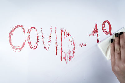 Person holding text against white background