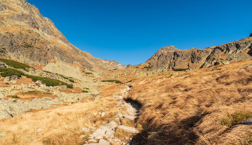 Scenic view of mountains against clear blue sky