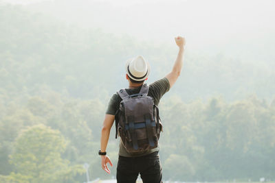 Rear view of man standing against mountain