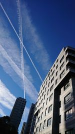 Low angle view of buildings against blue sky