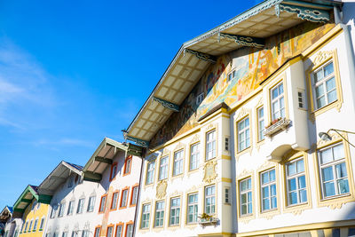 Low angle view of buildings against blue sky