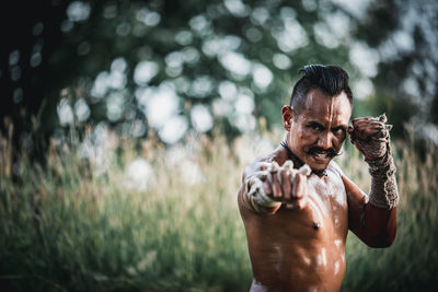 Portrait of young man standing outdoors