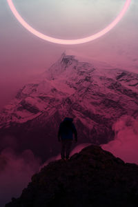 Man standing on mountain against sky
