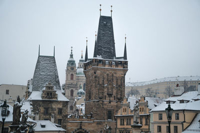 View of the charles bridge and the malostranska tower on a winter day. prague czechia