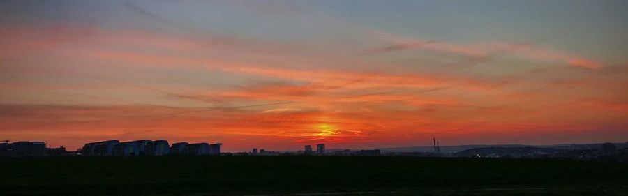 Silhouette buildings against sky during sunset