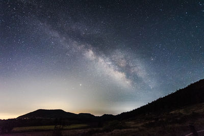 Scenic view of silhouette mountain against sky at night