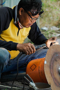 Side view of man working at workshop