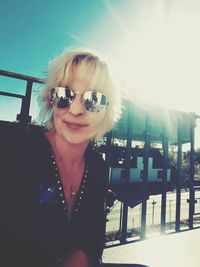 Portrait of woman wearing sunglasses against sky