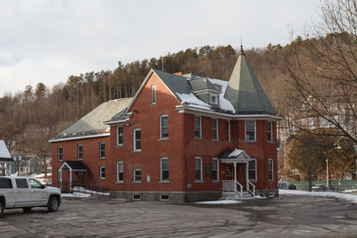 Building by road against sky in city