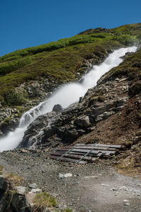 Scenic view of waterfall against clear sky