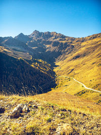 Scenic view of mountains against clear blue sky