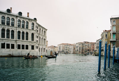 View of boats in canal along buildings