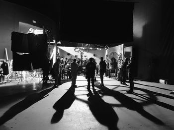 People walking on illuminated street in city