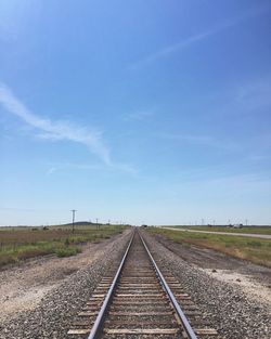 Railroad tracks against blue sky