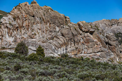 Low angle view of rocky mountains against sky