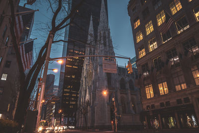 Low angle view of illuminated buildings against sky at night