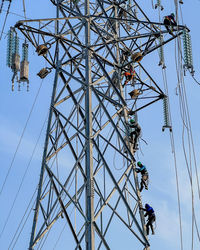 Low angle view of electricity pylon against sky