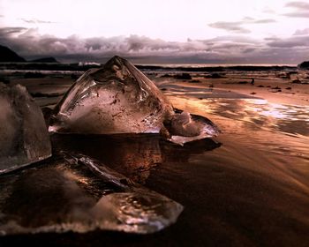 Ice rocks on the beach at sunrise 