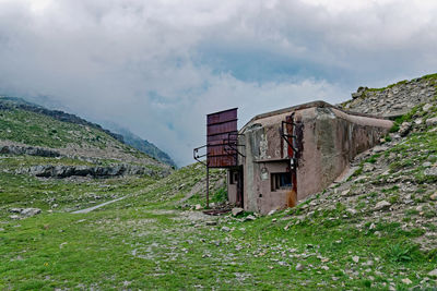 Old building on mountain against sky