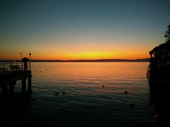 Scenic view of lake against orange sky