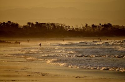 Scenic view of beach against sky during sunset