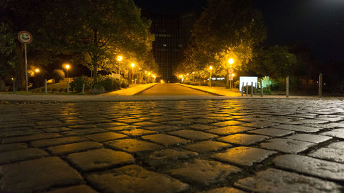 Illuminated walkway in city at night